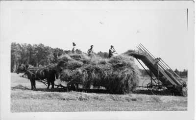 Three Men on a Haying Wagon and a Hay loader, Thessalon area, circa 1920