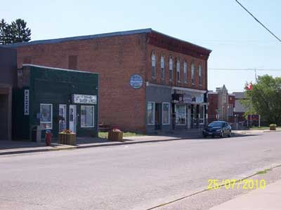 East Side of Main Street, Between Huron and Algoma (Former Western Tire building and Mills Department Store)