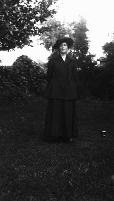 Lucy Maud Montgomery modelling wedding trousseau.  Clothes purchased in Montreal, 1911.  Leaskdale, ON.