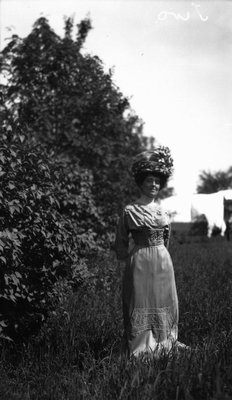 Lucy Maud Montgomery modelling wedding trousseau.  Clothes purchased in Montreal, 1911.  Leaskdale, ON.