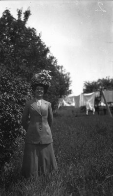 Lucy Maud Montgomery modelling wedding trousseau.  Clothes purchased in Montreal, 1911.  Leaskdale, ON.