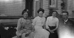 Lucy Maud Montgomery, baby Douglas McIntosh, Margaret Ross Stirling, Mabel Simpson McIntosh & Rev. Major Hooper McIntosh.  Cavendish Manse, P.E.I., 1910.