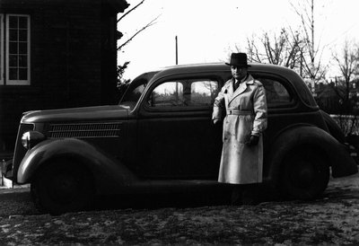 Chester beside car, in driveway of 210 Riverside Drive, Toronto, ON.