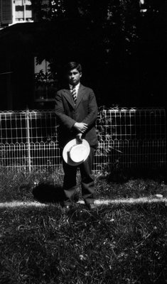 Chester standing in front of fence holding hat, Norval ON.