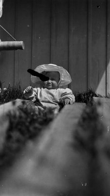 Chester as a baby with sun hat.