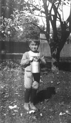 Stuart with Paddy the cat in bucket, age 5 1/2 years, ca.1921.  Leaskdale, ON.