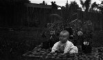 Stuart as a baby, sitting on a rug in the garden, Leaskdale, ON.