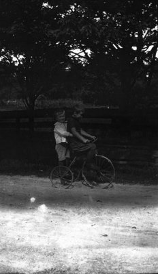 Stuart & Chester on a bicycle.