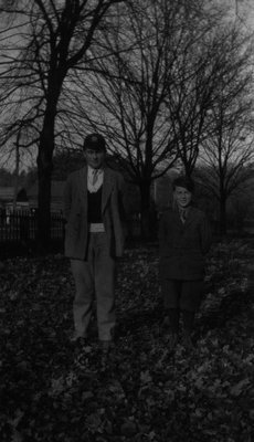 Stuart & Chester standing in leaves.