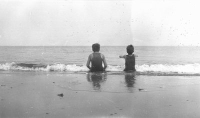 Stuart & Chester sitting in the sand, P.E.I.