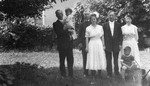 Unidentified man holding Stuart, Ewan, Miss Fraser, Mrs. Fraser, Lucy Maud Montgomery and Chester, ca.1920.  Leaskdale, ON.