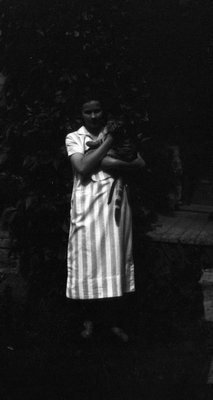 Woman (unidentified) holding cat.