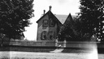 Front of Leaskdale Manse from across the street, with child in wagon