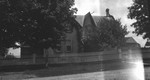 The Manse, with boy at front gate, Leaskdale, ON.