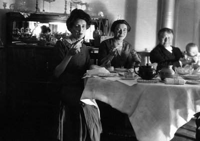 Lucy Maud Montgomery, Frede, Ewan and baby at dining table.  Leaskdale, ON.