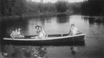 Tourists in a canoe at McAmmonds Camp, circa 1930