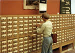 Woman using card catalogue at Wilfrid Laurier University Library
