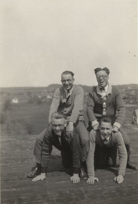 Four Waterloo College students on the roof of Willison Hall