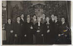 John Reble and a group of men standing in a church