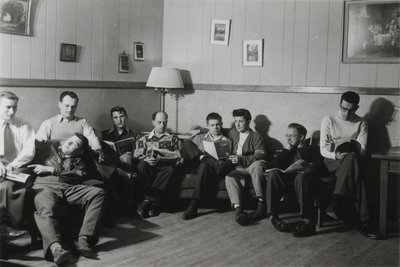 Nine male students in men's common room, Waterloo College