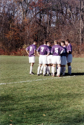 Wilfrid Laurier University men's soccer team in a huddle