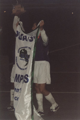 Wilfrid Laurier University men's soccer players with OUA banner and trophy