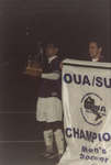 Wilfrid Laurier University men's soccer players with OUA banner and trophy