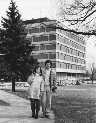 Two alumni in front of Library, Wilfrid Laurier University