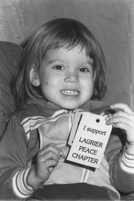 Child holding an &quot;I support Laurier Peace Chapter&quot; card