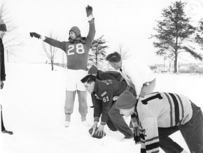 Waterloo College students playing football in the snow