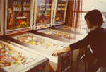 Student playing pinball in the Students' Union games room, Wilfrid Laurier University