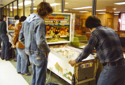 Students playing pinball in the Students' Union games room, Wilfrid Laurier University