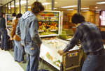 Students playing pinball in the Students' Union games room, Wilfrid Laurier University