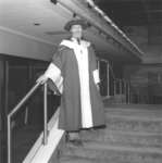 Ken Thomas wearing Wilfrid Laurier University doctoral candidate gown, hat and hood