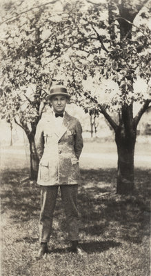 Earle Shelley standing under cherry trees