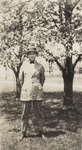 Earle Shelley standing under cherry trees