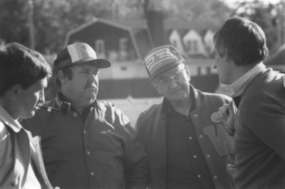 Four men at Seagram Stadium, Wilfrid Laurier University