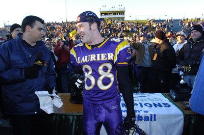 Andy Baechler preparing for post game interview at the Yates Cup