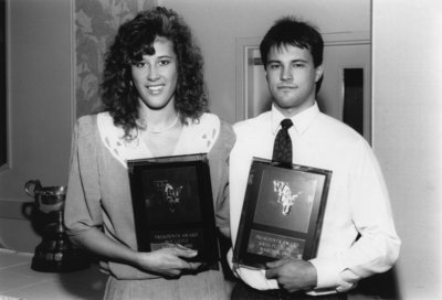 Sue Little and Greg Puhalski with athletic awards