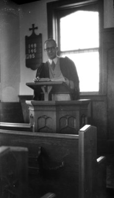 Earle Shelley standing at podium in chapel