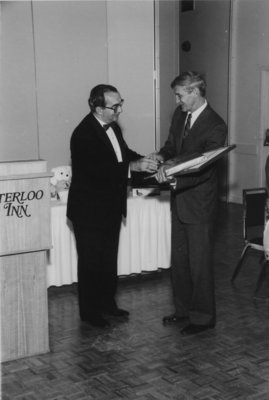 John Weir presenting the Professor of the Year Award to Don Morgenson