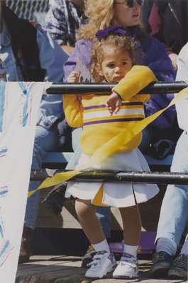 Young girl taking in a Homecoming football game