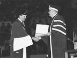 Jean Chrétien and John Black Aird shaking hands at convocation