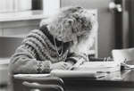 Woman seated at table in Wilfrid Laurier University Library