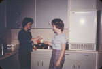 Two female students in a Clara Conrad kitchen, Waterloo Lutheran University