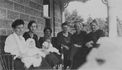 Women and children sitting on a porch