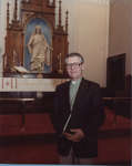 Rev. David Metzger in front of altar