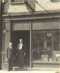 Jacob Conrad and Jacob Janzen standing in front of hardware store