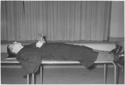 Waterloo Lutheran University Choir Member lying on a table