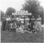 Group of people in front of sign, Camp Edgewood, 1956